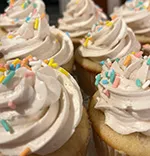 imagery holiday themed sugar cookies on a plate, there is a cupcake on the plate aswell