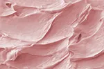 pink buttercream spread evenly over a surface